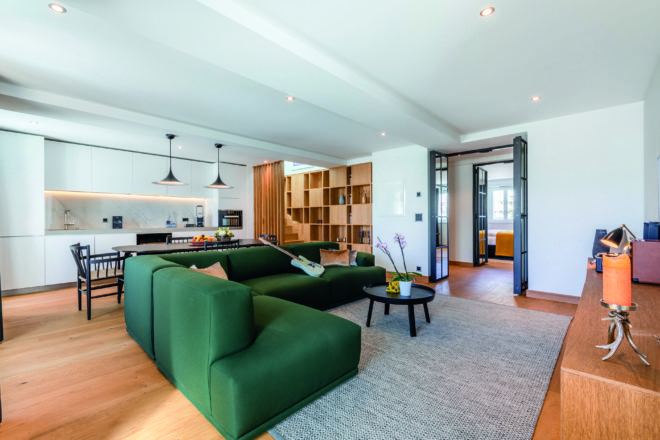 The spacious open-plan living and dining area of a unit at The Residences at Hard Rock Hotel, Davos, Switzerland