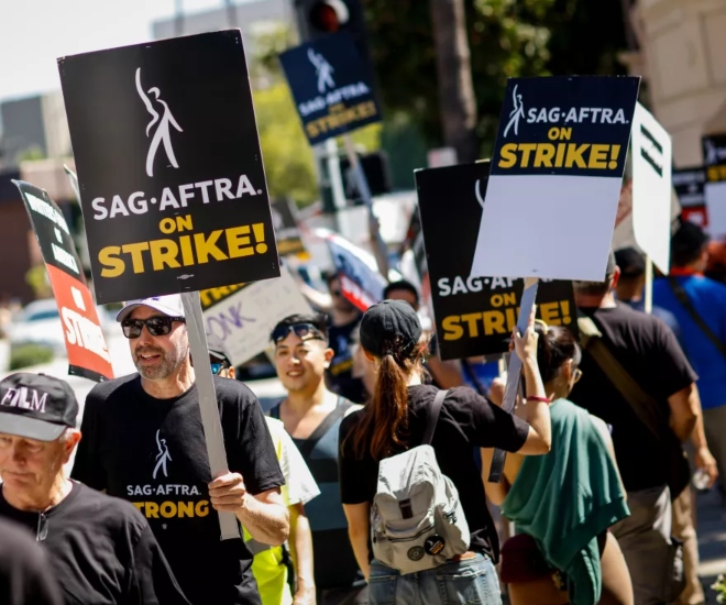 Members of SAG-AFTRA and the Writers Guild of America picket outside the Warner Bros. studio lot, in Burbank. (Jay L. Clendenin/Los Angeles Times)