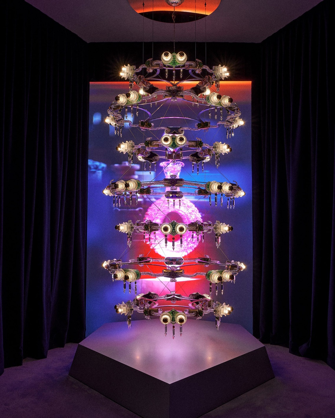 Bethan Laura Wood posing with her modular, sci-fi-gothic inspired chandelier for Baccarat. Image: Dezeen.