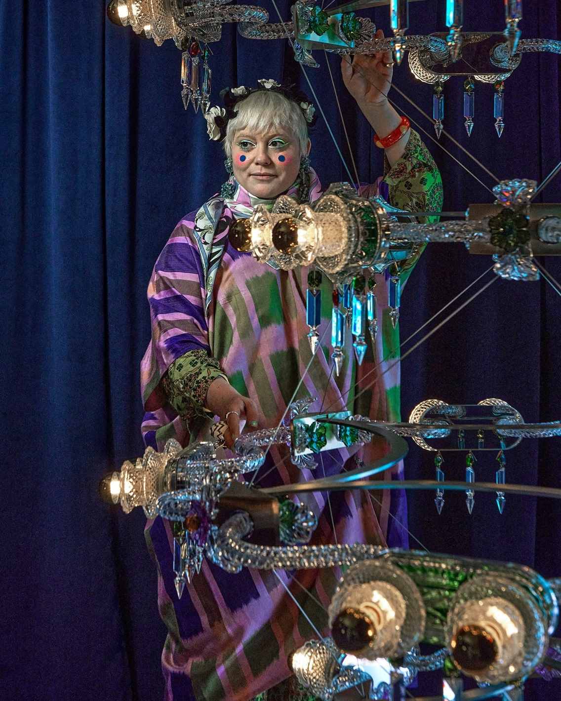 Bethan Laura Wood posing with her modular, sci-fi-gothic inspired chandelier for Baccarat. Image: Dezeen.