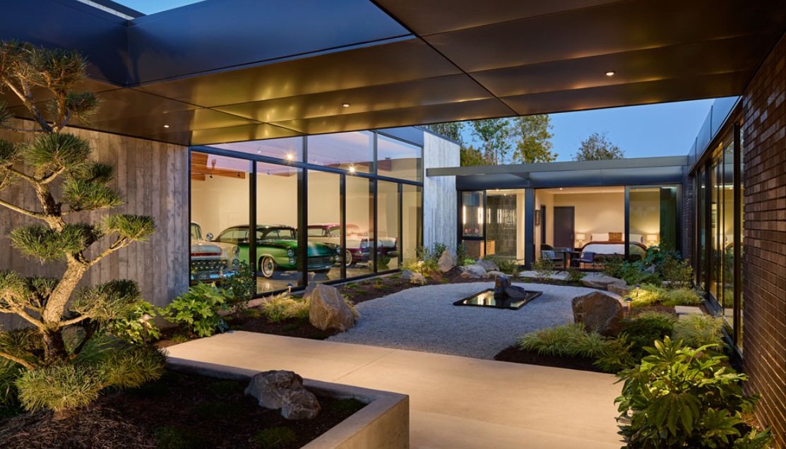 Lush gardens and an expansive car gallery wrap this charming residence. Image: futurehouseaward.com