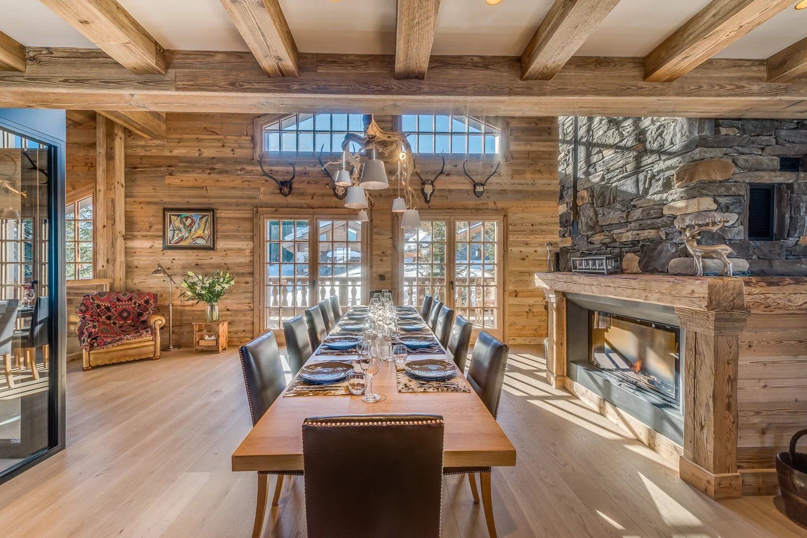 A large dining room offering a commanding view of the Alps at an Alpine chalet in Courchevel. Image: Savills.